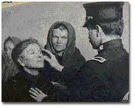 An immigrant receives an eye examination.