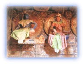 Clay figurines and frescoes in the Tabo Monastery. Credit: Discover India