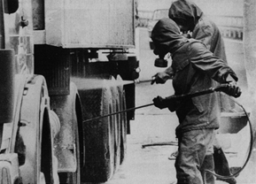 [Worker washing down a truck]